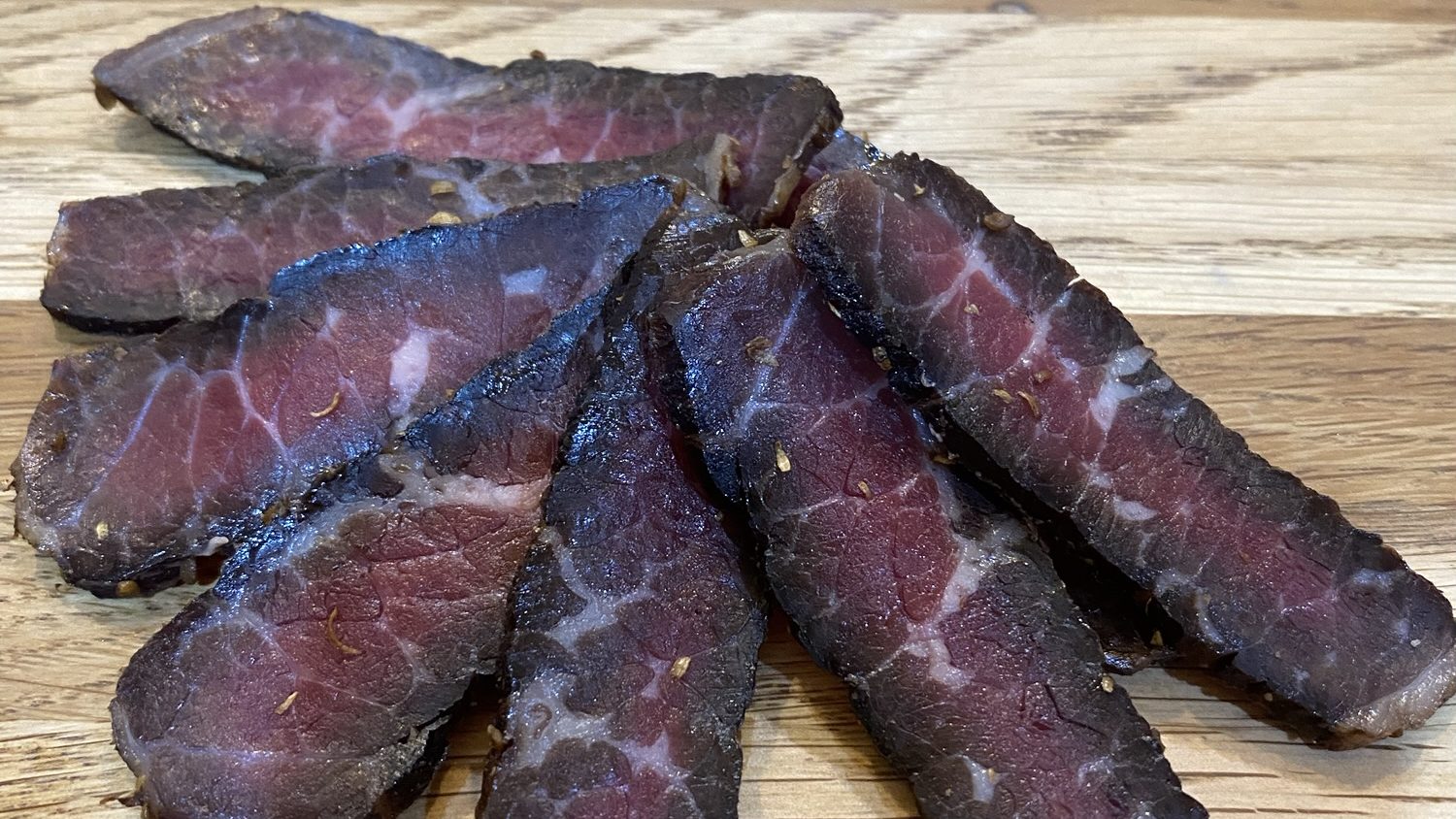 Freshly sliced Harpenden Biltong on a wooden board